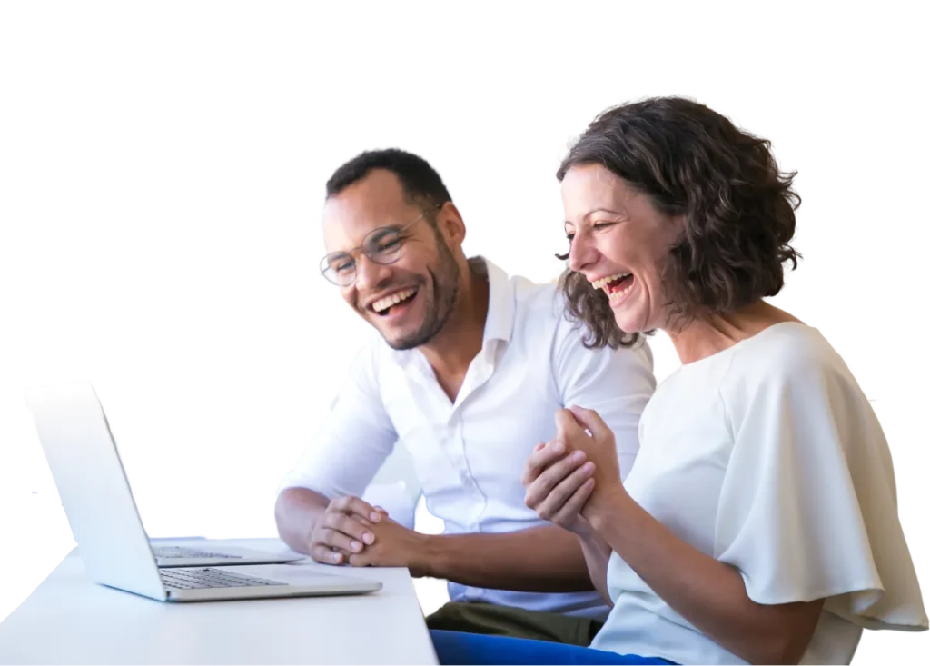 Hombre y mujer riendo frente a computodora